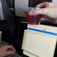 Illustration for article titled Breaking: Flight Attendant Currently Attempting To Pass Cup Of Cranberry Juice Over Your Laptop